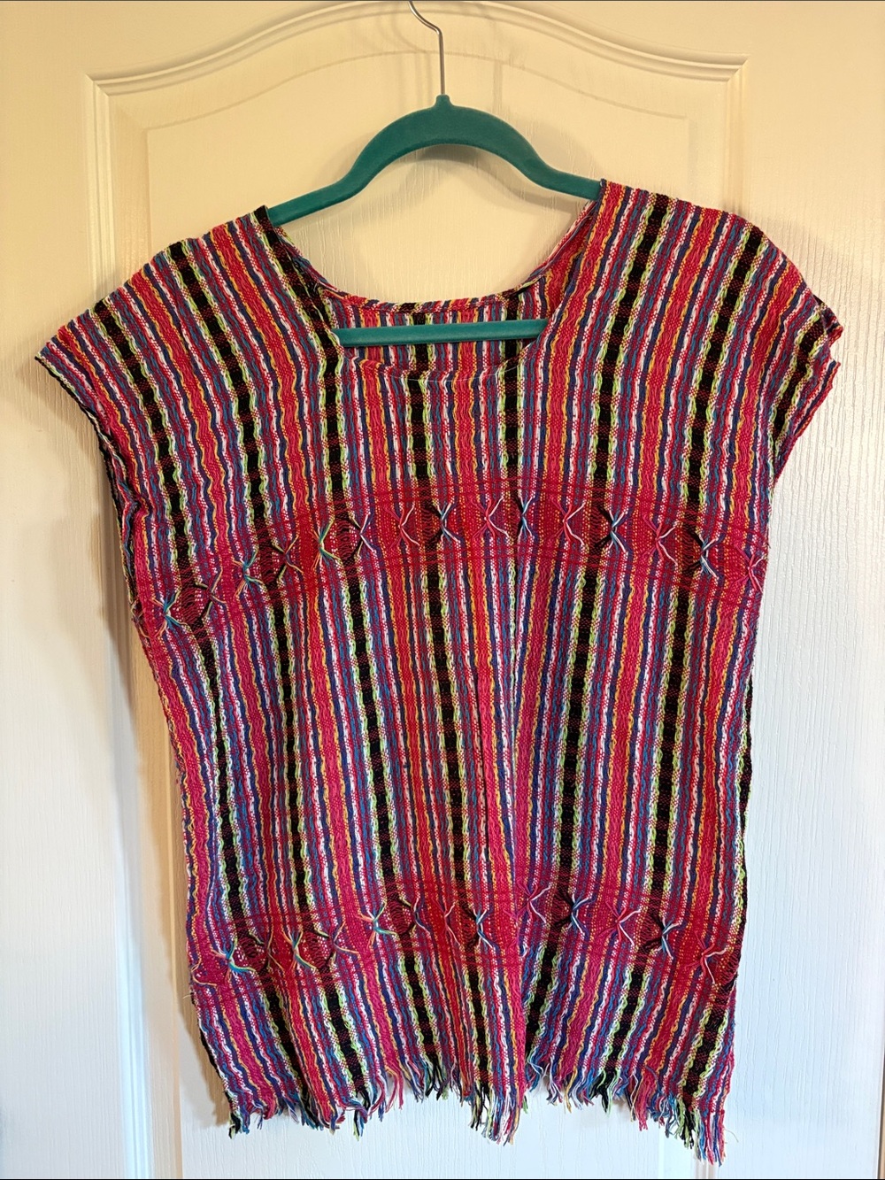 Multi color handwoven Oaxacan treadle top with a fringed hem.